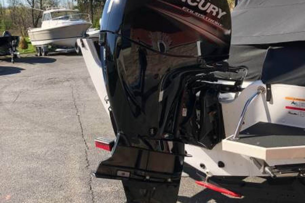 Black motor attached to back of boat