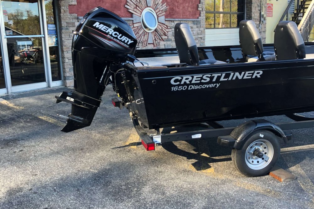 Back end of black boat with outboard motor