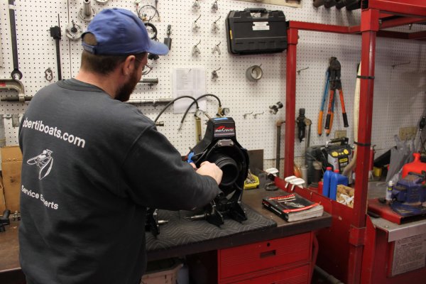 Staff person at work station with motor parts