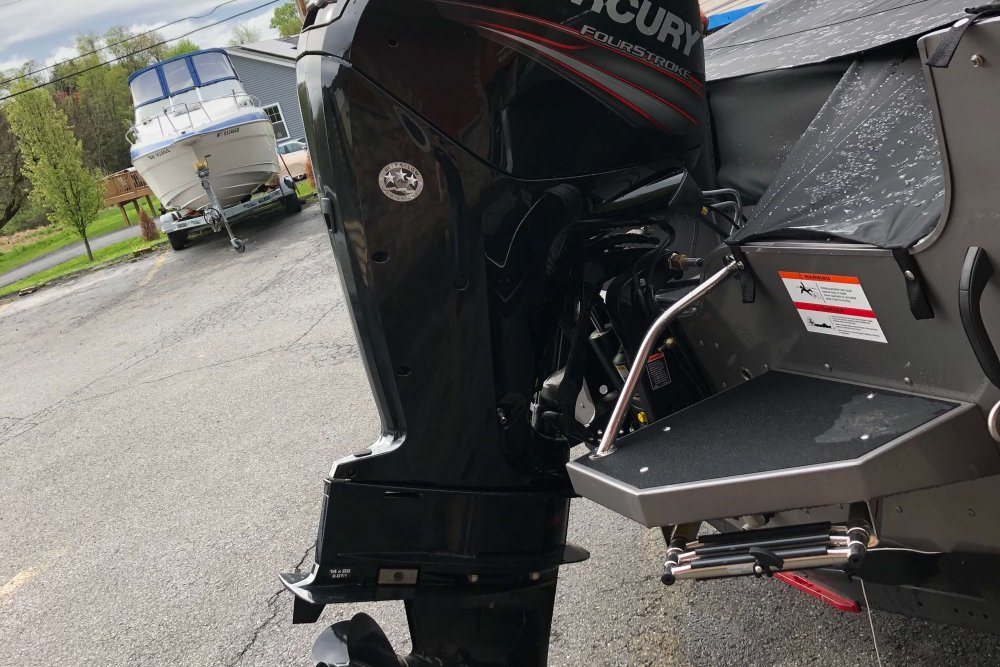 Black outboard motor on back of boat